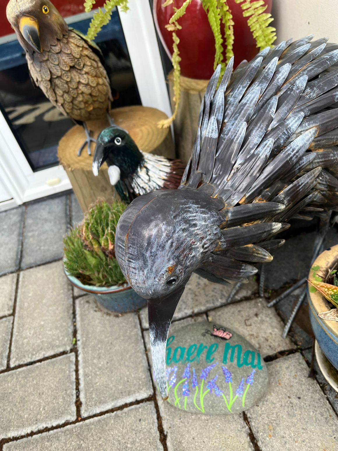 A steel kiwi and other decorations at the entrance to the centre